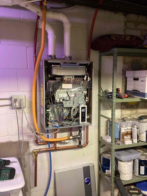 Diagnosed and serviced Richmond tankless water heater displaying error code 11. Cleaned flame sensor with sand cloth to resolve intermittent operation issue. Equipment functioning properly upon completion of service. Submitted order form for replacement flame sensor as preventative measure.