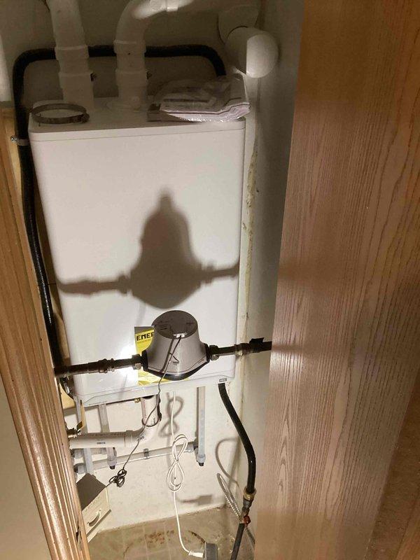 Removed non-functional tankless water heater and installed new wall-mounted unit, utilizing existing 3" ventilation system. Successfully completed all necessary connections including copper and PVC piping, pressure regulator installation, and electrical wiring for the replacement unit.