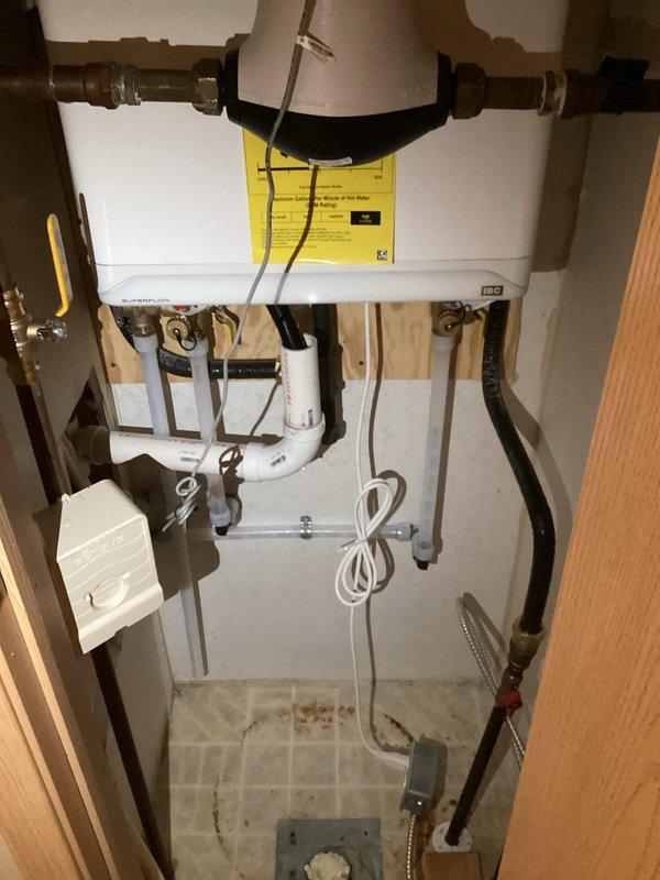 Removed non-functional tankless water heater and installed new wall-mounted unit, utilizing existing 3" ventilation system. Successfully completed all necessary connections including copper and PVC piping, pressure regulator installation, and electrical wiring for the replacement unit.