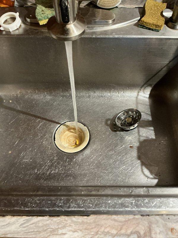 Responded to service call for a clogged kitchen sink drainage issue. Inspected the plumbing system including P-trap and drain connections, then successfully cleared the blockage. Verified proper drainage by testing with running water, confirming complete restoration of normal sink function.