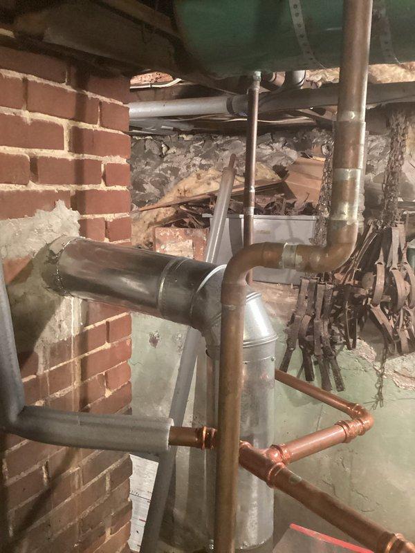 Responded to callback for no heat upstairs. Identified air lock in the system and resolved by bleeding significant air from purge valves where lines ascend to upper floor. Found and closed an incorrectly opened bypass valve which restored proper flow. System currently operational but noted several design issues including incorrectly piped expansion tank and questionable piping configuration. Recommended installation of conventional bladder tank with air scoop, auto fill, repipe on boiler return, and addition of glycol due to pipes running along exterior walls in this historic structure.