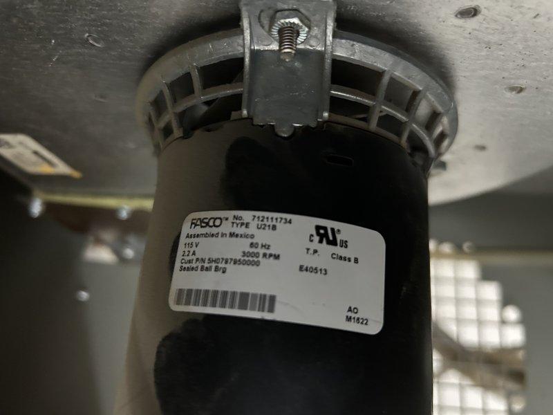 Diagnosed no heat complaint on shop's Modine garage heater. Discovered seized inducer motor despite unit being only approximately three years old. Removed inducer assembly, confirmed wheel was rubbing and preventing rotation. Identified FASCO U21B motor (model #712111734, 115V/60Hz/2.7A/3000RPM) as failed component. Replaced inducer motor to restore proper heater operation.