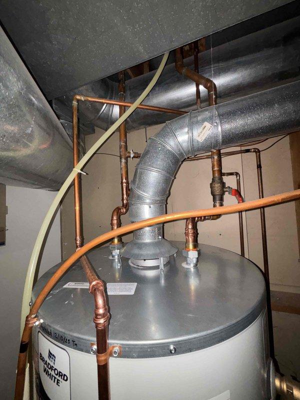 Successfully replaced a leaking 75-gallon natural gas power vent water heater due to tank failure. Installation included proper connection of copper lines, venting system, and all required valves. Bradford White unit was installed and tested to ensure proper operation.
