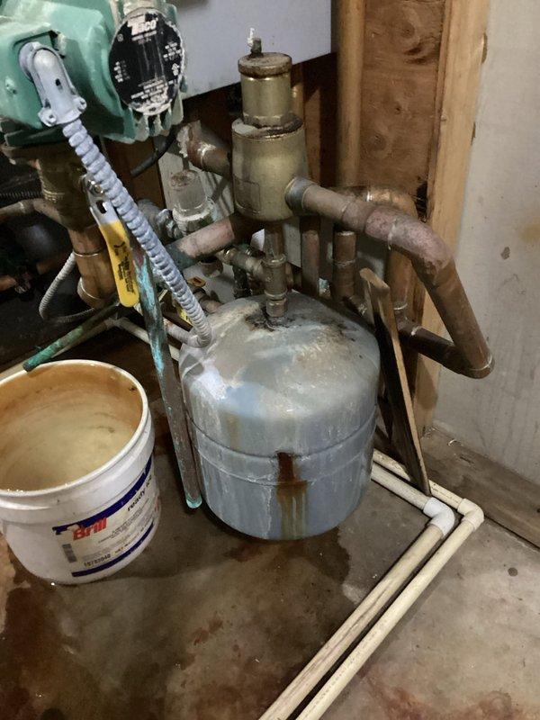 Responded to leaking boiler issue previously diagnosed by technician. Identified pinhole leak in expansion tank spraying water and a faulty relief valve on hot water holding tank. Observed severe corrosion throughout system, particularly on control board and multiple fittings. System operational despite deteriorated condition. Discussed replacement options with homeowner, who requested both immediate repair of expansion tank and relief valve plus consultation regarding potential full boiler replacement. Scheduled follow-up with service advisor for replacement quote.