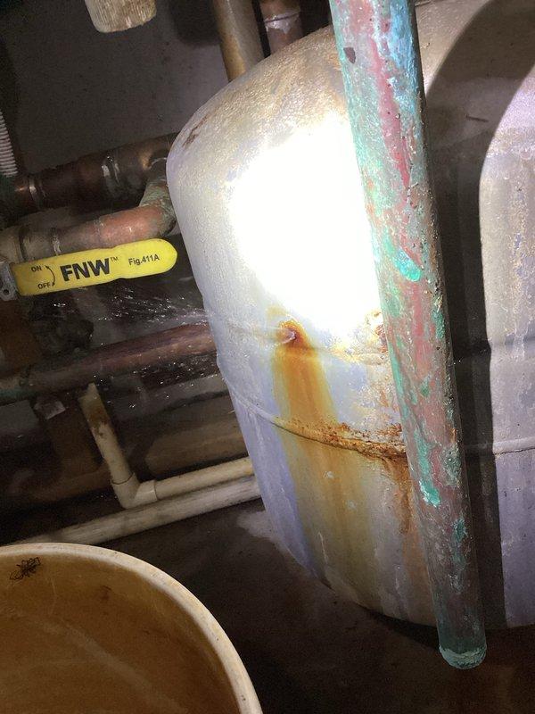 Responded to leaking boiler issue previously diagnosed by technician. Identified pinhole leak in expansion tank spraying water and a faulty relief valve on hot water holding tank. Observed severe corrosion throughout system, particularly on control board and multiple fittings. System operational despite deteriorated condition. Discussed replacement options with homeowner, who requested both immediate repair of expansion tank and relief valve plus consultation regarding potential full boiler replacement. Scheduled follow-up with service advisor for replacement quote.