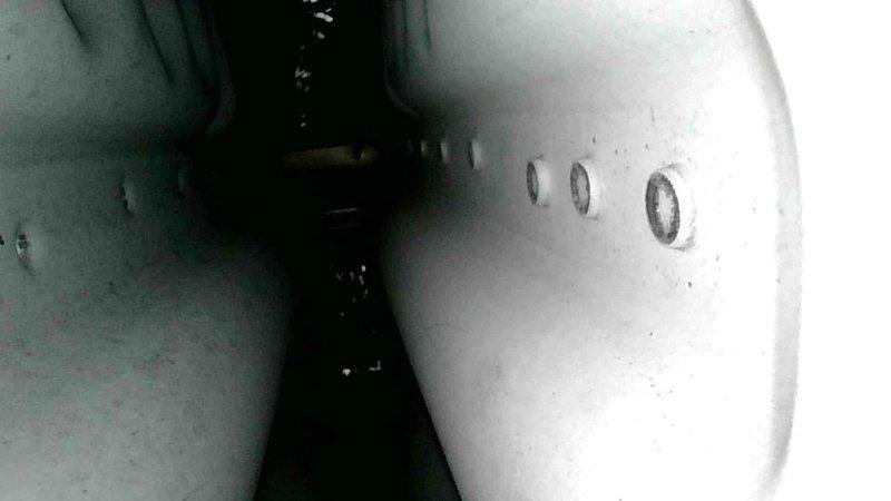 Performed scheduled furnace tune-up on 9-year-old Carrier system. Inspected all components which were operating properly. Identified water leak from humidifier; advised homeowner to replace water panel to resolve the issue. Documentation includes photos of ductwork with inspection ports and evaporator coil with notable frost accumulation.