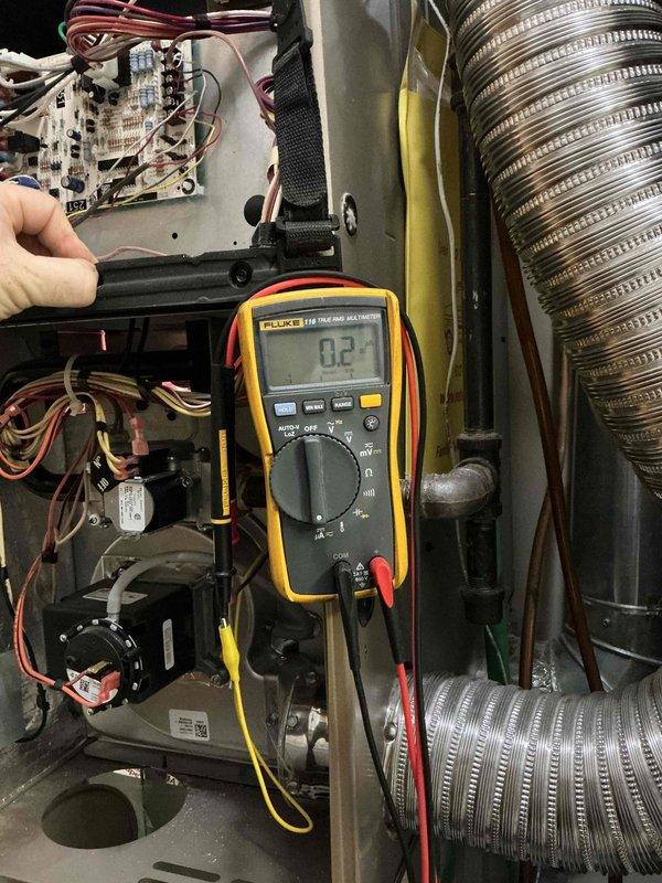 Responded to no heat complaint for 5-year-old York furnace. Diagnosed weak flame sensor signal, performed cleaning of flame sensor which restored proper microamp readings (approximately 2 µA). Conducted comprehensive system check with multimeter verification showing all other components functioning correctly. Unit now operating safely with normal heat production.