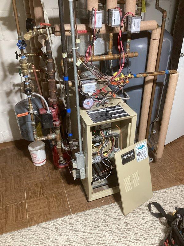 Performed comprehensive boiler maintenance that included replacement of defective zone valve head, expansion tank with zero PSI pressure, and unresponsive boiler pressure gauge per customer's approval. During inspection, discovered water pressure irregularities when adding water, confirmed with secondary gauge testing. All components successfully replaced and tuneup completed; system now functioning properly with restored pressure regulation.