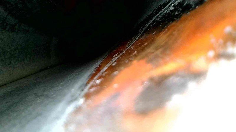 Performed diagnostic assessment on non-functional Lennox furnace exhibiting flame rollout from burner box with subsequent fault shutdown. Visual inspection revealed critical heat exchanger failure with significant cracking in the chamber adjacent to ignitor. Documented equipment condition with photos of heat exchanger, data plate, and furnace for warranty processing.