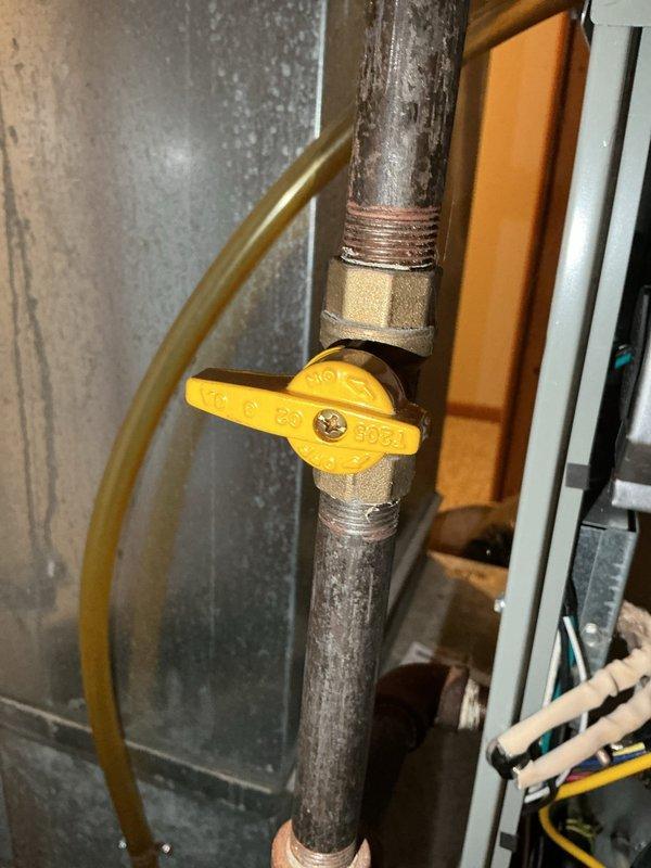 Performed furnace tune-up inspection on 13-year-old unit, discovering a cracked heat exchanger. Due to critical safety concern, recommended complete furnace replacement. Documented gas valve and connection points showing signs of oxidation/corrosion on the copper/brass piping system.