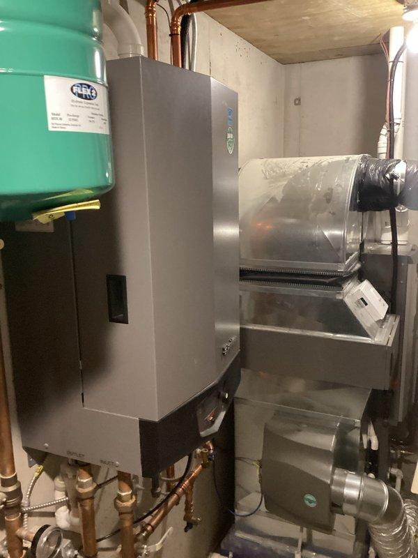 Performed annual maintenance on two residential heating systems: 10-year-old boiler and 11-year-old furnace under rewards membership program. Disassembled and cleaned ultra boiler heat exchanger in main house, replaced customer-supplied humidifier water panel and filters. Restored disconnected thermostat to proper operation. At cottage, serviced furnace by cleaning flame sensor and condensate components, and performed standard boiler maintenance without disassembly as inspection indicated minimal fouling. All systems verified operational upon completion.