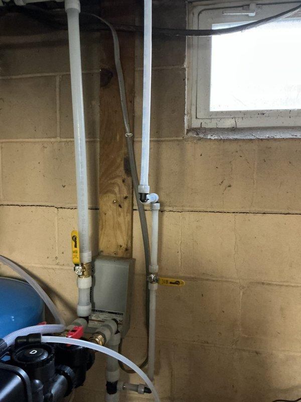 Responded to service call regarding exterior faucet installation and washing machine connection. Located and opened shut-off valve to restore water supply to washing machine. Completed installation of outdoor bibb/faucet including necessary piping connections to integrate with existing plumbing system.