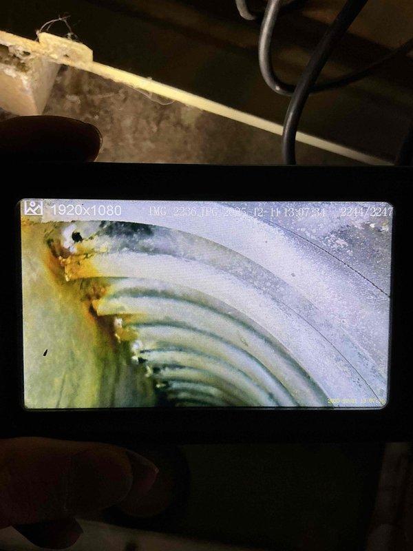 Responded to no heat complaint on 15+ year old furnace producing burning odor and fan noise. Performed diagnostic inspection revealing failed heat exchanger with significant corrosion and discoloration as confirmed by camera inspection of interior chambers. Unit also exhibited motor failure. Presented replacement options to customer due to age of system and safety concerns.
