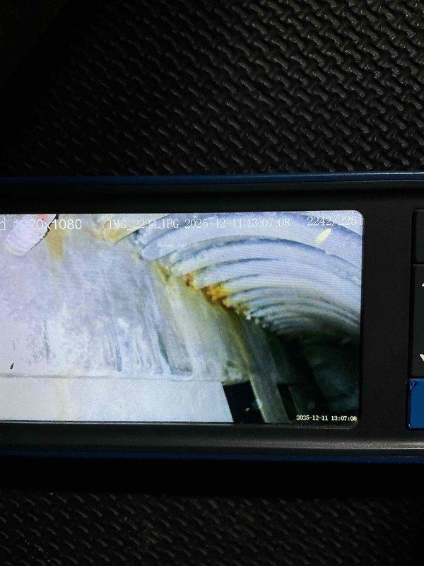 Responded to no heat complaint on 15+ year old furnace producing burning odor and fan noise. Performed diagnostic inspection revealing failed heat exchanger with significant corrosion and discoloration as confirmed by camera inspection of interior chambers. Unit also exhibited motor failure. Presented replacement options to customer due to age of system and safety concerns.
