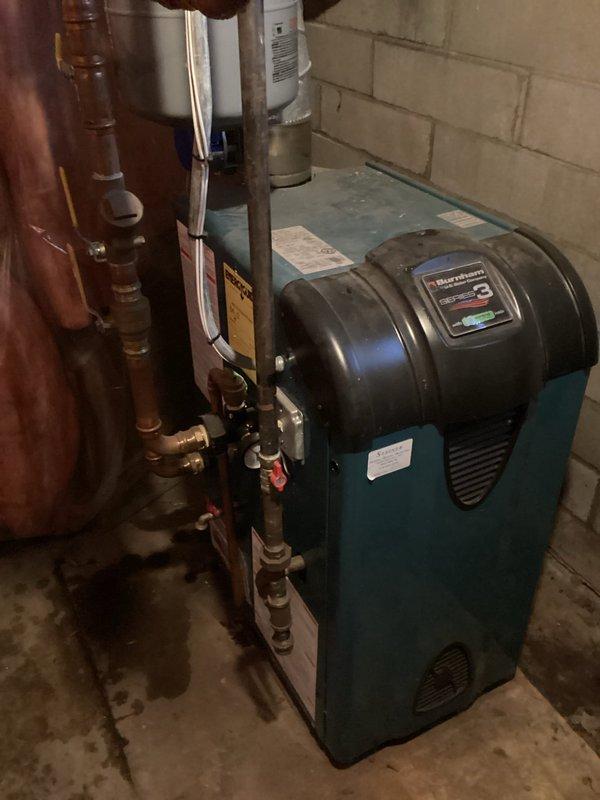 Inspected water leak reported through ceiling. Cut access opening to investigate source, finding no active leakage after water was restored. Identified low boiler pressure (5 psi) as possible contributor; recharged system to 20 psi. Monitored for one hour with water restored to confirm resolution. Potential cause may be ice dam related; no ongoing leakage observed during service period.