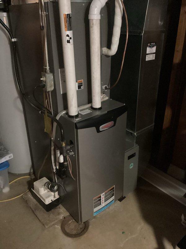 Performed comprehensive furnace tune-up on 4-year-old Lennox FRP system. Inspected all electrical components, cleared condensate lines, verified clean filter and blower assembly. Examined heat exchanger (no compromises found), confirmed proper gas pressures, and checked venting system. Unit operated within specifications with appropriate temperature rise of approximately 60 degrees. Exterior condensing unit observed with substantial snow accumulation.