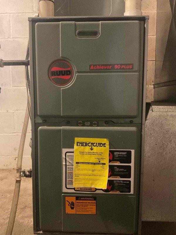 Responded to customer's no heat complaint on a 28-year-old Ruud Achiever 90 Plus natural gas furnace. Diagnostic revealed furnace would ignite but shut down shortly after, with visible water leakage from inducer hoses and significant rust on the inducer motor and pressure switch. Due to age and extensive deterioration, replaced the entire unit rather than attempting repair of the failing components.