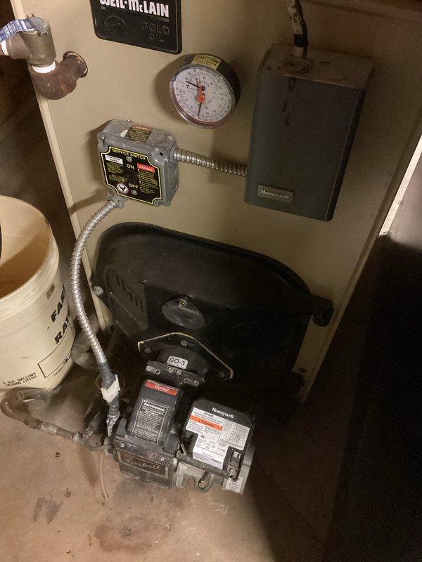 Responded to no-heat call for oil-fired Weil-McLain boiler system. Diagnosed multiple issues including low water level in system, disconnected zone valve wire, and noisy circulator pump. Refilled system, reconnected zone valve wiring, and restored heat to residence. Recommended replacement of circulator pump, installation of backflow preventer, replacement of auto fill valve, and updating the aging zone control board. System operational upon departure.