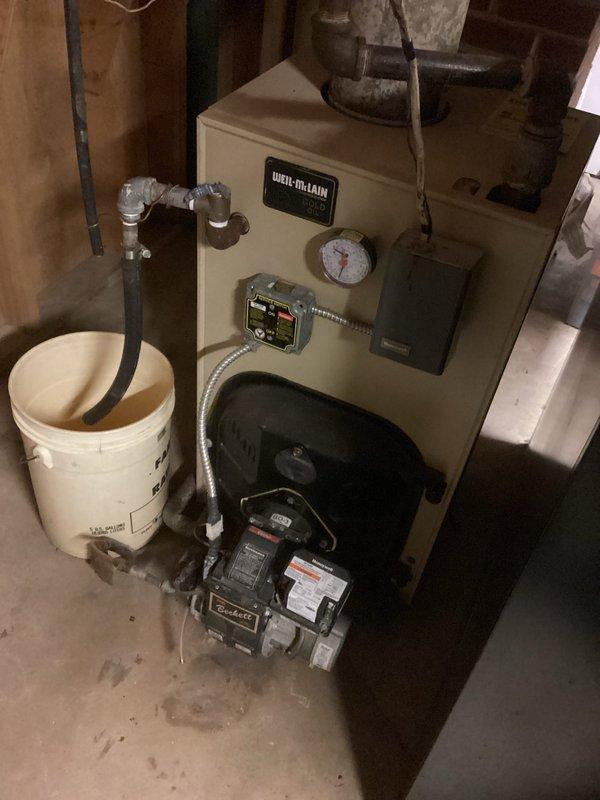 Responded to no-heat call for oil-fired Weil-McLain boiler system. Diagnosed multiple issues including low water level in system, disconnected zone valve wire, and noisy circulator pump. Refilled system, reconnected zone valve wiring, and restored heat to residence. Recommended replacement of circulator pump, installation of backflow preventer, replacement of auto fill valve, and updating the aging zone control board. System operational upon departure.
