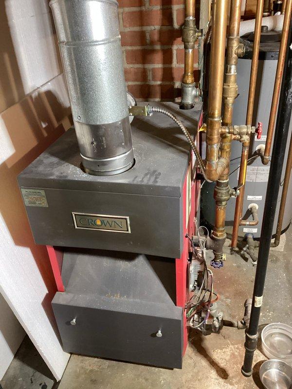 Inspected residential heating system and water softener following client report of leaks. Identified leak at boiler manifold where copper pipes connect to the Crown unit. Observed aged water softener with excessive salt consumption, though not actively leaking during inspection. Provided quote for replacement water softener unit to address ongoing maintenance concerns.
