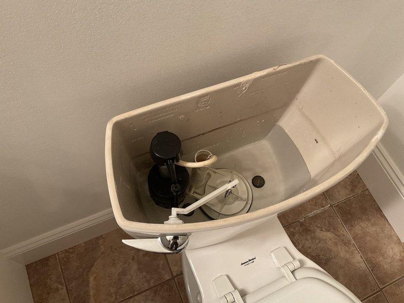 Responded to service call for lower level toilet leak. Investigation revealed tank-to-bowl bolt was leaking due to customer's elderly husband falling against the toilet tank. Successfully resolved issue by tightening tank-to-bowl bolts and checked water supply connections to ensure proper function.