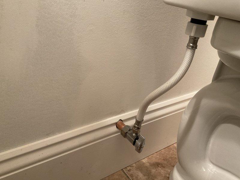 Responded to service call for lower level toilet leak. Investigation revealed tank-to-bowl bolt was leaking due to customer's elderly husband falling against the toilet tank. Successfully resolved issue by tightening tank-to-bowl bolts and checked water supply connections to ensure proper function.