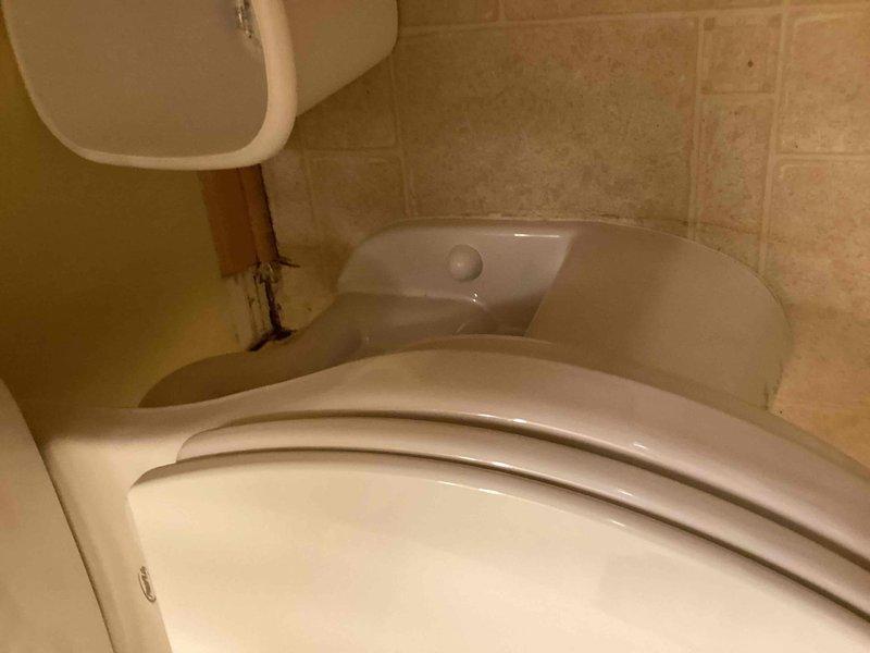 Responded to service call for toilet leaking from underneath bowl area. Upon inspection, identified worn tank-to-bowl gasket as the source of the leak. Replaced the entire toilet unit to resolve the issue. Verified proper installation and confirmed no further leakage.