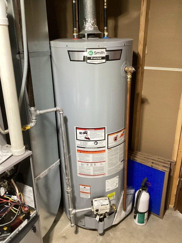 Resolved water leakage near condensate trap on 3-year-old gas furnace by identifying the actual source was a loose hose clamp on exhaust rubber boot. Tightened clamp, ran furnace for 20 minutes to verify leak elimination. System operational with no further issues.