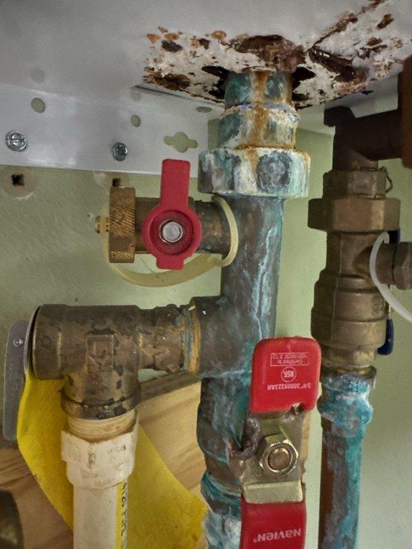 Inspected Navien tankless water heater exhibiting severe internal leaking and corrosion on plumbing components. Documented extensive water damage and oxidation on copper pipes and brass fittings. Initiated warranty claim with Navien for unit replacement, submitted documentation and awaiting authorization.