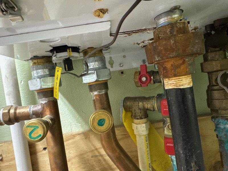 Inspected Navien tankless water heater exhibiting severe internal leaking and corrosion on plumbing components. Documented extensive water damage and oxidation on copper pipes and brass fittings. Initiated warranty claim with Navien for unit replacement, submitted documentation and awaiting authorization.