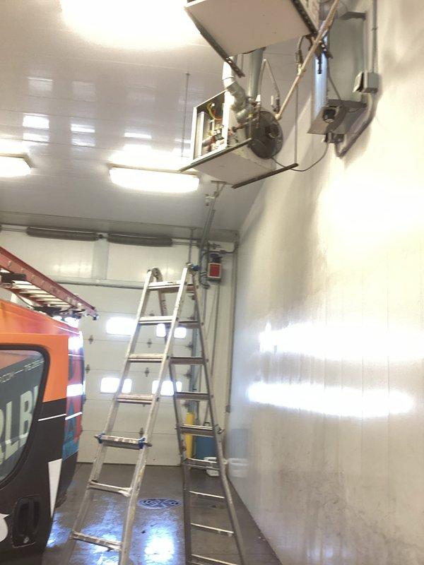 Responded to no-heat call for two 11-year-old Reznor unit heaters in wash bays. Diagnosed and replaced failed thermostat on larger unit and discovered concentric vent intake issue causing exhaust recirculation; temporarily disconnected intake to allow unit to draw room air. For smaller unit, cleaned flame sensor which restored operation. Noted larger unit's fan motor and control board showing significant deterioration. Scheduled follow-up with service advisor to evaluate complete replacement options for both aging units.