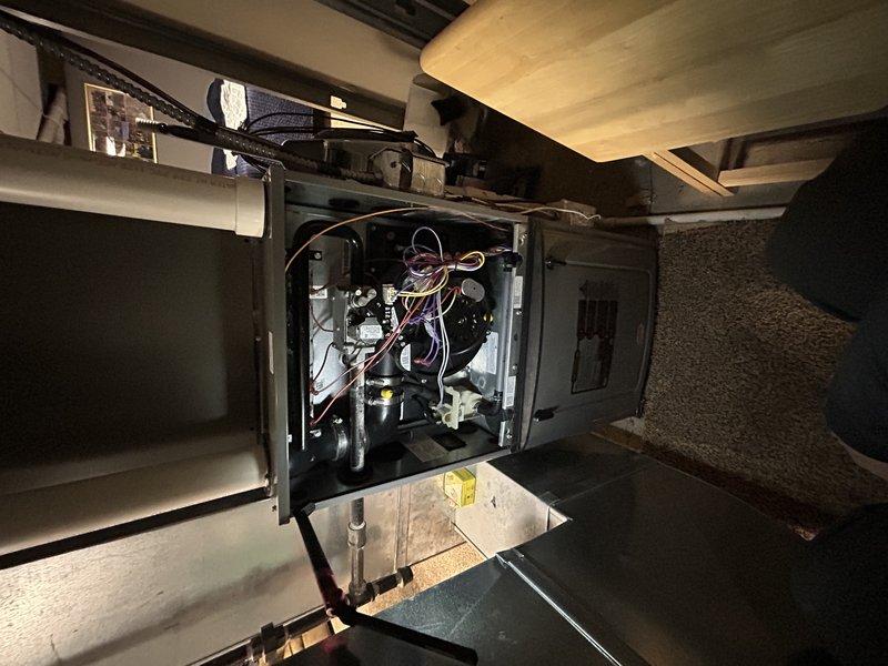 Responded to no heat call on a 7-year-old Honeywell system. Determined thermostat was in delay mode, not malfunctioning. Performed complete tune-up including cleaning components, checking venting for snow buildup, clearing condensate drain, and replacing improperly installed air filter. Verified proper gas pressure, temperature rise, and heat exchanger condition. System now operating normally.