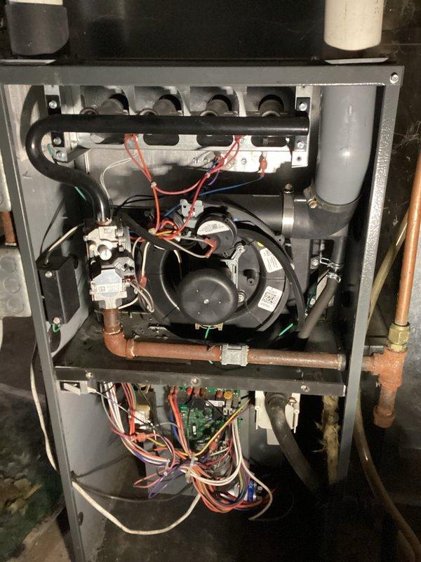 Diagnosed furnace issue where unit was igniting but not blowing air through vents. Investigation revealed control board failure preventing power from reaching blower motor. As a temporary solution until homeowner decides on repair or replacement options, rewired fan to run continuously to provide some heat during cold weather. Recommended control board replacement or potential furnace upgrade. Service advisor scheduled to provide replacement system pricing options.