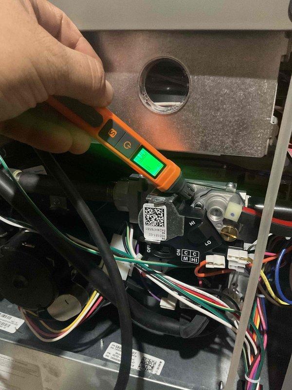 Responded to no heat emergency call for recently installed Lennox furnace (WT 07-2035). Upon arrival, unit was running but not producing heat with thermostat set to 68°. Inspection revealed minor debris (3 moths) in intake screen. Performed diagnostic testing with multimeter on internal components to identify ignition failure issue. System was attempting to cycle but failing to establish flame.