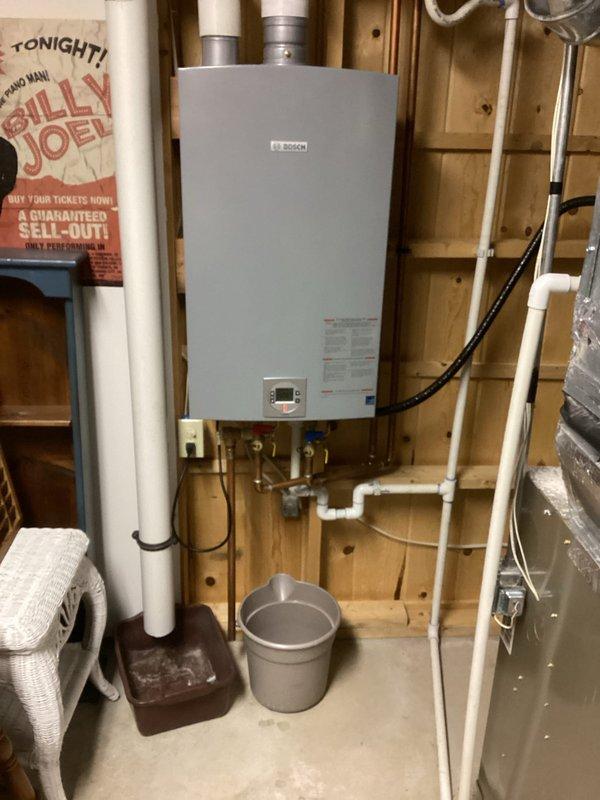 Performed diagnostic assessment on Bosch tankless water heater experiencing insufficient heating capacity for tub applications while maintaining adequate temperature (126°F) for sink fixtures. Completed comprehensive inspection of intake/venting system, ignitor, flame sensor, burner assembly, and heat exchangers, identifying heat exchanger scale buildup and control board errors. System exhibited shutdown issues following flush procedure. Scheduled follow-up service with technician Jared and arranged for comfort advisor to present repair/replacement options.