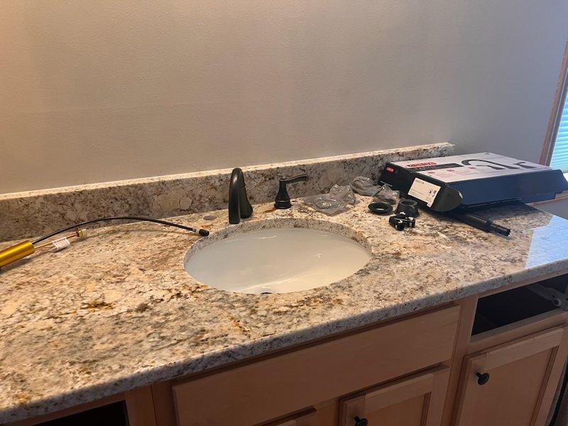Completed installation of three customer-supplied lavatory fixtures and one kitchen faucet as requested. Successfully rehooked kitchen drain connection to ensure proper drainage. All fixtures were tested for functionality and correct water flow with no leaks observed.