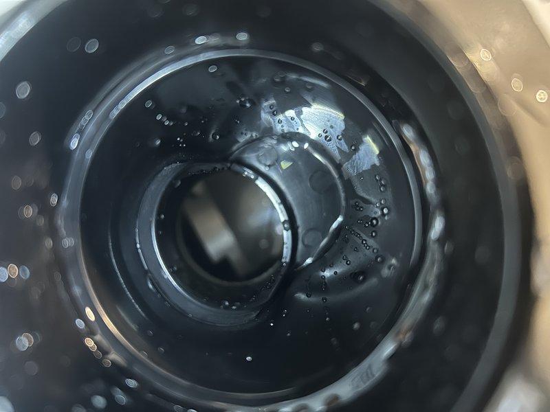 Responded to no heat call and found inducer motor heavily saturated with water. Cleared debris from condensate drainage system, particularly from the blue strainers at drain connection points. Tested system by pouring water through exhaust pipe and drain tubes, confirming proper flow through trap and drain line. After reassembly, monitored furnace operation for approximately 50 minutes total with consistent condensate drainage and no water accumulation in inducer.