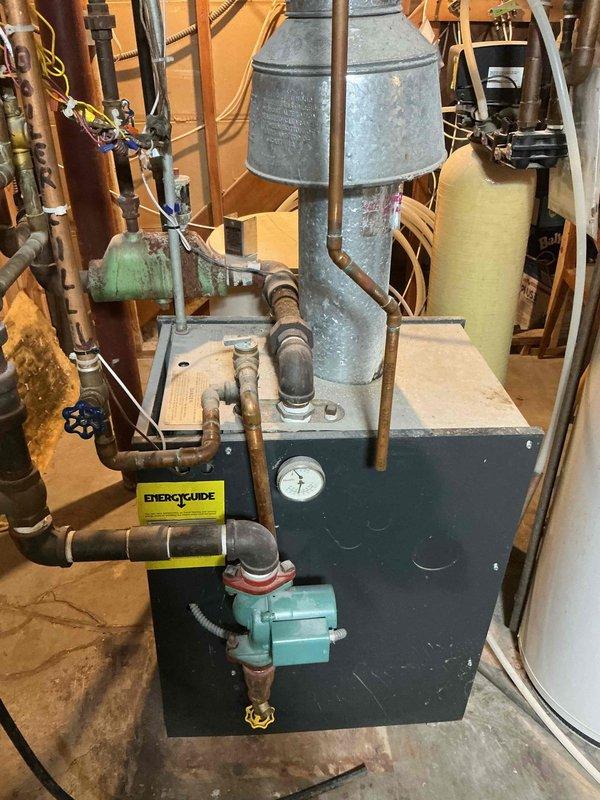 Responded to service call regarding sticking oiler valve on customer's Slant/Fin boiler. Diagnosed zone valve stuck in open position causing improper system operation. Replaced faulty zone valve and verified proper system pressure (within operational range on pressure/temperature gauge). System now functioning correctly.