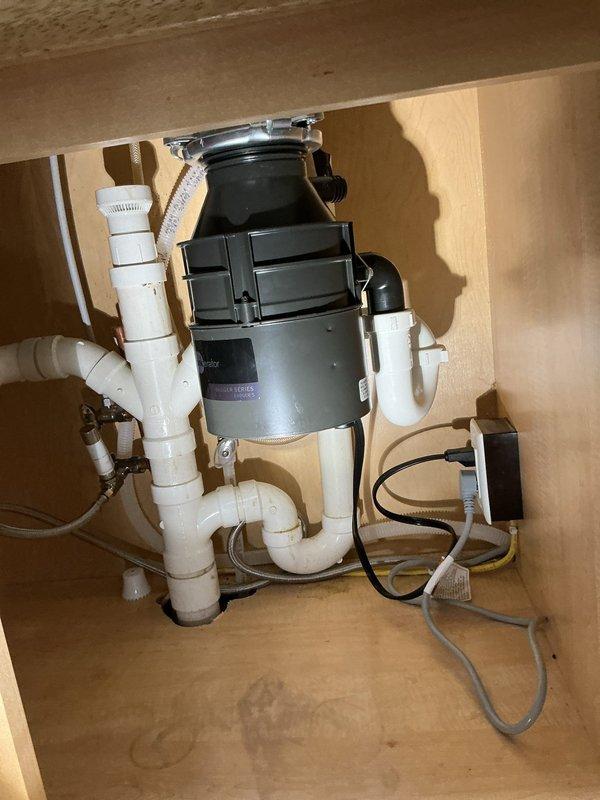 Replaced outdated plumbing components in kitchen, including installation of new water shut-off valve and supply line for dishwasher connection. Removed existing disposal unit and installed new garbage disposal with proper connections to sink drain system. All systems tested and functioning properly after service.