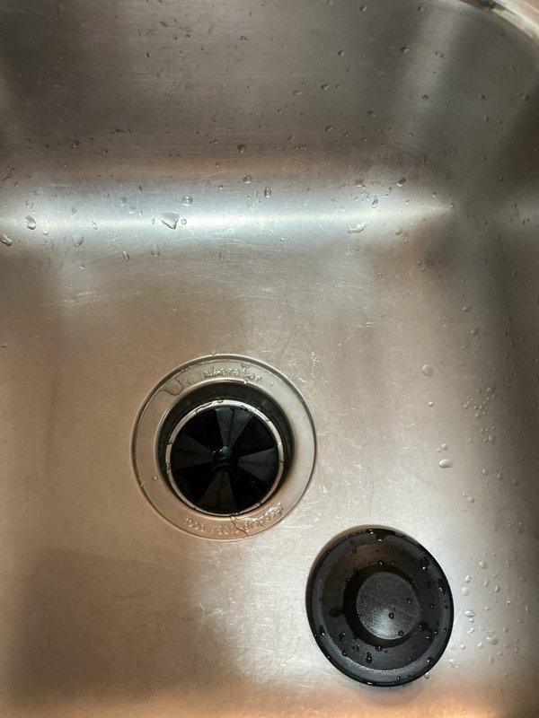 Replaced outdated plumbing components in kitchen, including installation of new water shut-off valve and supply line for dishwasher connection. Removed existing disposal unit and installed new garbage disposal with proper connections to sink drain system. All systems tested and functioning properly after service.
