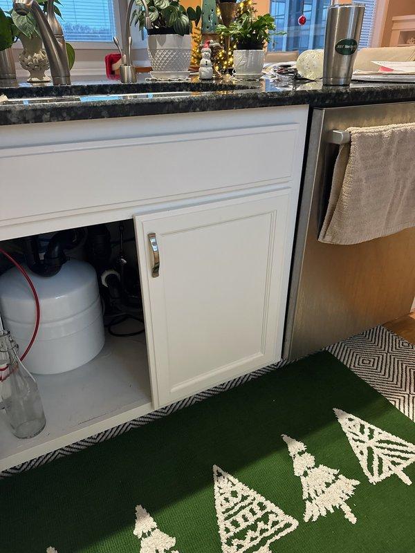Responded to an emergency call for water damage in customer's ceiling. Upon inspection, identified two sources of leakage in the kitchen island above: a malfunctioning reverse osmosis pump and a defective faucet sprayer. Removed the unnecessary RO pump and provided replacement parts for the faucet to resolve the issue.