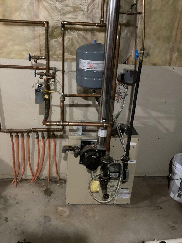 Diagnosed and serviced in-floor heating system that was failing to operate properly. Found zone valve at boiler was seized in closed position, preventing proper flow to garage zone. Applied lubricant to free the seized valve stem and manually exercised component until proper operation was restored. Tested system functionality and confirmed heat delivery resumed to garage floor system. Customer advised that replacement of zone valve plunger assembly may be necessary if issue recurs.