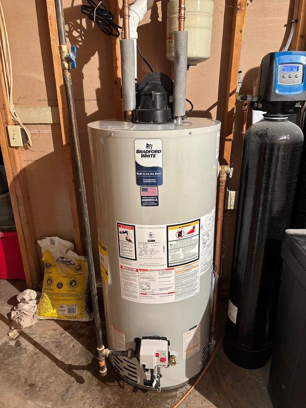 Responded to service call for a leaking Bradford White 50-gallon natural gas water heater, approximately 10 years old. Diagnostic inspection revealed a pinhole leak on the bottom skirt of the tank, requiring full unit replacement. Successfully installed new A.O. Smith ProMax water heater with proper connections to existing water lines and gas supply.