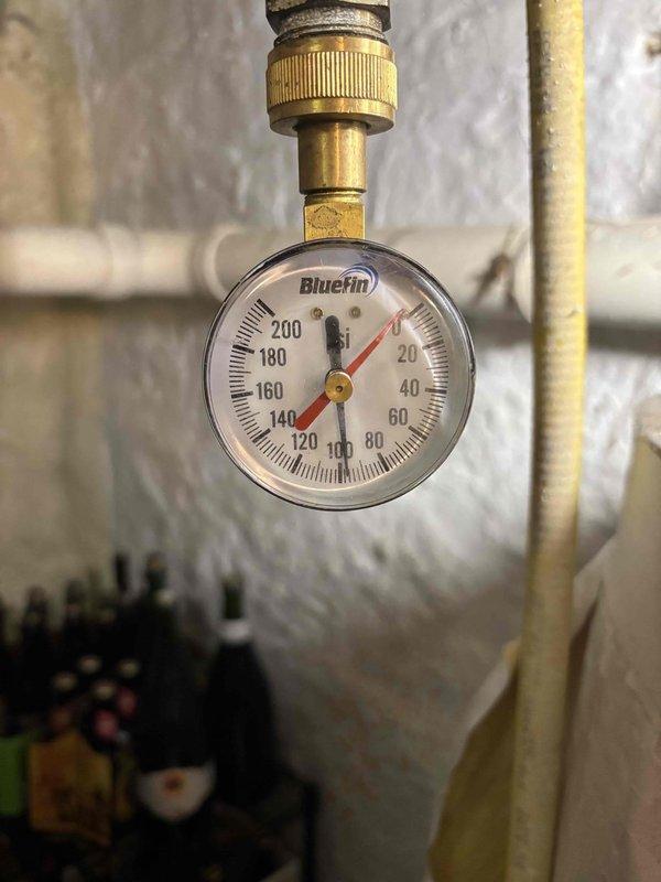 Responded to service call for leaking water heater (10+ years old, original to home). Diagnosed leak originating from stem near gas valve and found T&P valve leaking. Successfully replaced temperature and pressure relief valve to resolve immediate safety concern. Documented system condition with photos showing significant corrosion and mineral buildup in plumbing components. Recommended replacement of aging water heater and addition of expansion tank; customer will review estimate options.