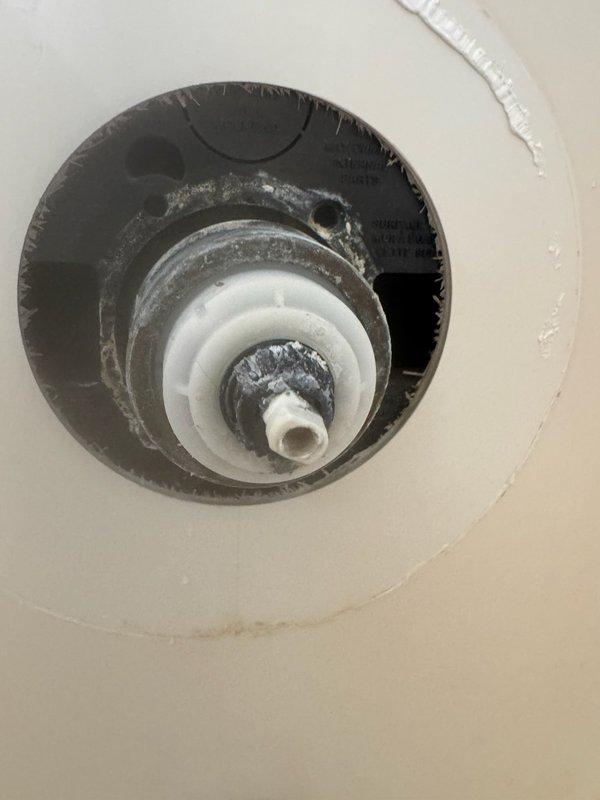 Responded to emergency service call for shower valve leak requiring complete home water shutoff. Upon inspection, found shower valve damaged from customer's attempted cartridge replacement, causing water to leak through valve body into basement ceiling. Accessed shower plumbing through wall opening and capped both hot and cold water lines to resolve the immediate leak issue.