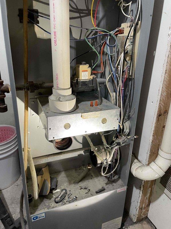 Performed diagnostic on no heat call for aging natural gas furnace. Found unit partially disassembled upon arrival with damaged inducer motor housing (plastic components broken). Visual inspection revealed rusty heat exchanger though no obvious compromises detected. Due to unit condition and uncertain parts availability, recommended system replacement. Initiated parts search for inducer motor and scheduled consultation with comfort advisor.