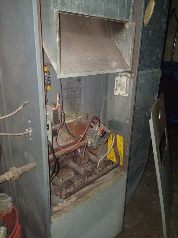 Responded to no-heat call for a 30-year-old furnace with intermittent pilot light issues. Upon inspection, discovered multiple cracks in the heat exchanger and severely plugged burners creating hazardous ignition conditions. Due to safety concerns and the deteriorated state of critical components evidenced by extensive rust and oxidation, the unit was tagged out of service. Arranged for sales advisor to discuss replacement options with homeowner.