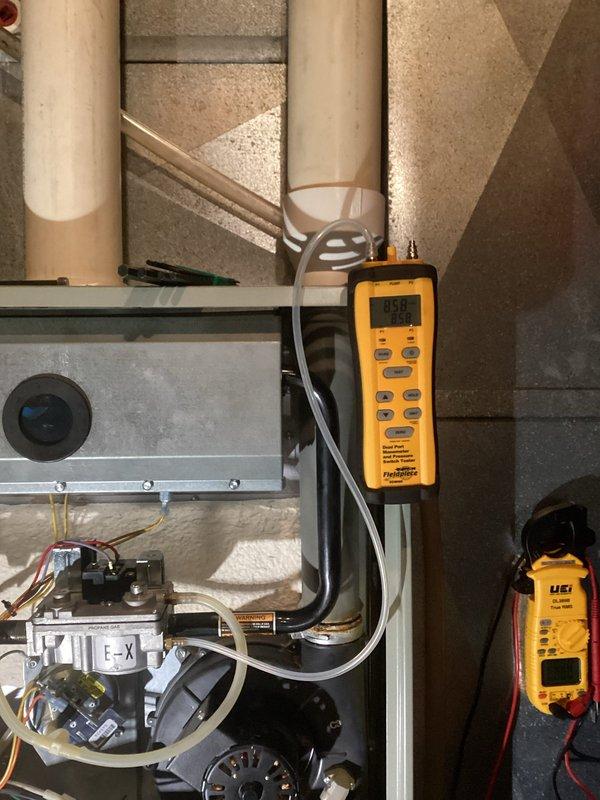 Performed comprehensive furnace tune-up on 25-year-old system. Identified several concerning components including blower with excessive play, capacitor degradation (15μF reading 12.3μF), problematic inducer motor operation, severely corroded flame exchanger, and defective inducer capacitor (4μF reading 0.6μF). Heat exchanger inspection revealed no compromises. Verified system operation with proper gas pressures and 60° temperature rise. Recommended replacement of both motors and scheduled advisor visit to discuss system replacement options due to age and repair costs.