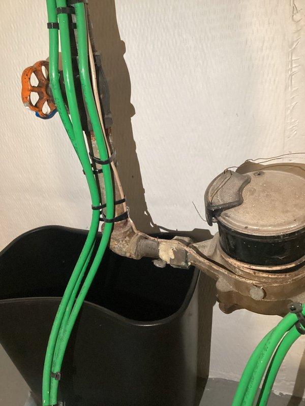 Responded to service call regarding leaking shut-off valve on incoming water line. Performed inspection of the plumbing system, which revealed significant leakage from the 12-4 shut-off valve. Green supply pipes showed signs of aging and mineral deposits at connection points. Temporarily addressed immediate leak issue and scheduled follow-up appointment for complete repipe service.