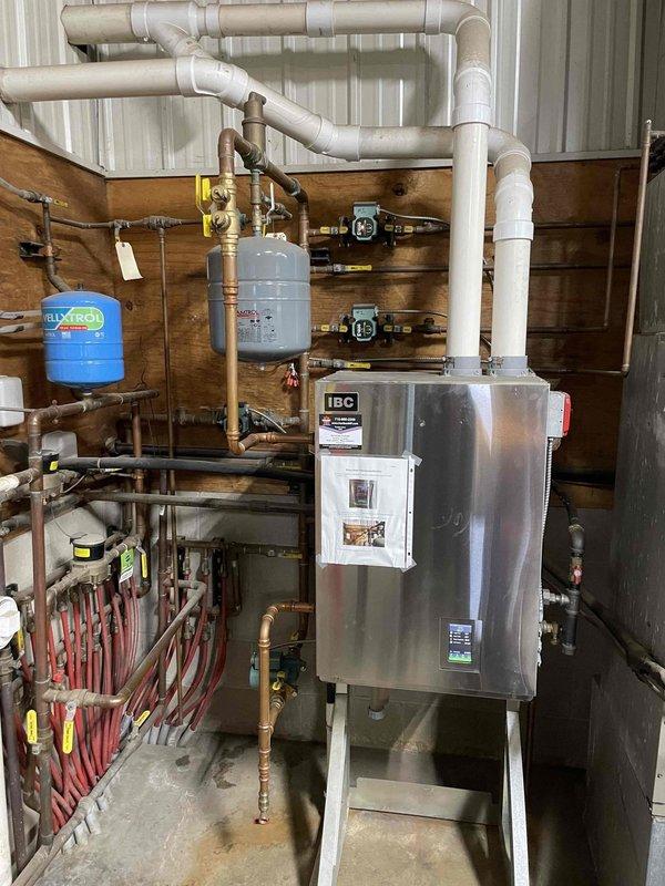 Responded to no heat call for a 2-year-old IBC boiler system. Diagnosed pressure loss due to a pinhole leak in the 007 primary loop circulator pump. Replaced defective pump, restored system pressure to 16 psi, and verified proper operation of both heating zones. System is now functioning correctly. Customer may benefit from upgrading their Nest thermostat to a T10 model for improved performance.